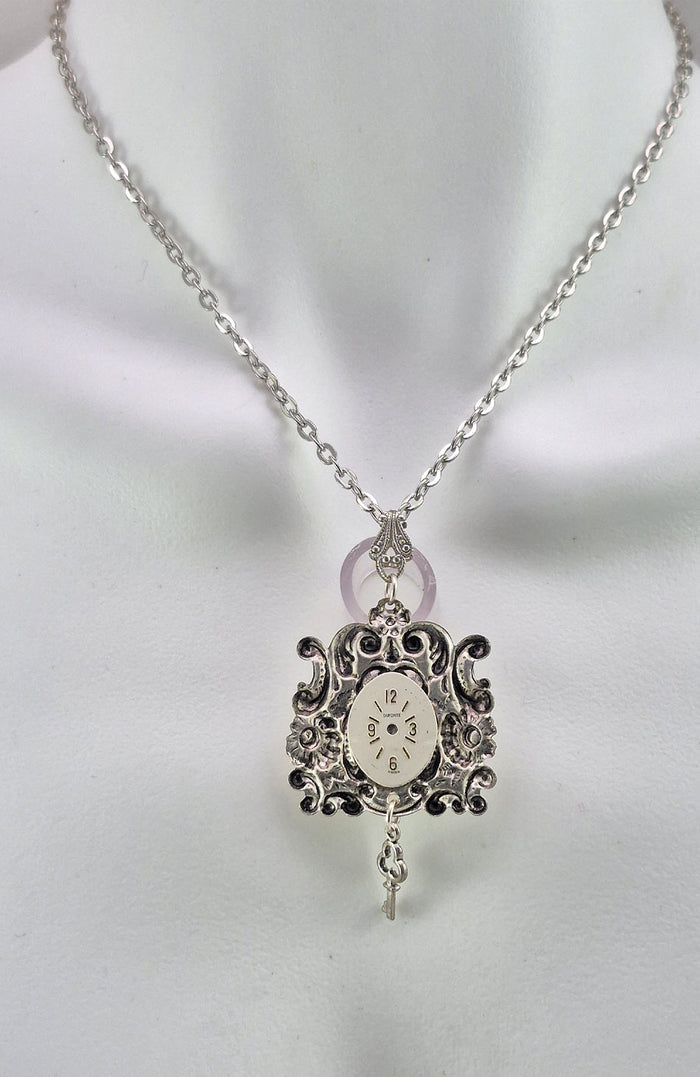 The back side of the pendant is decorated with an antique watch face unique to each piece.