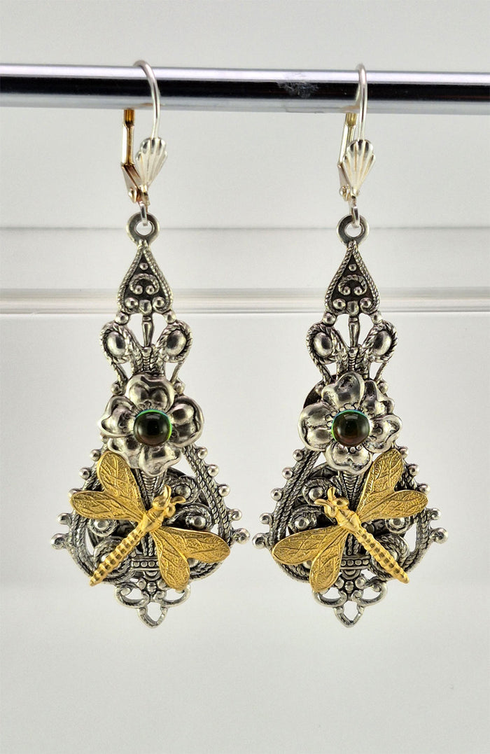 Sterling silver filled Victorian antique or reproduction work from original mold. The earrings feature an ornate silver filigree design embellished with a silver flower with iridescent green mini cabochon  &  a brass dragonfly motif, all mounted on lever back earring hooks.