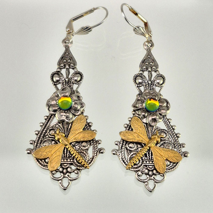 Sterling silver filled Victorian antique or reproduction work from original mold. The earrings feature an ornate silver filigree design embellished with a silver flower with iridescent green mini cabochon  &  a brass dragonfly motif, all mounted on lever back earring hooks.