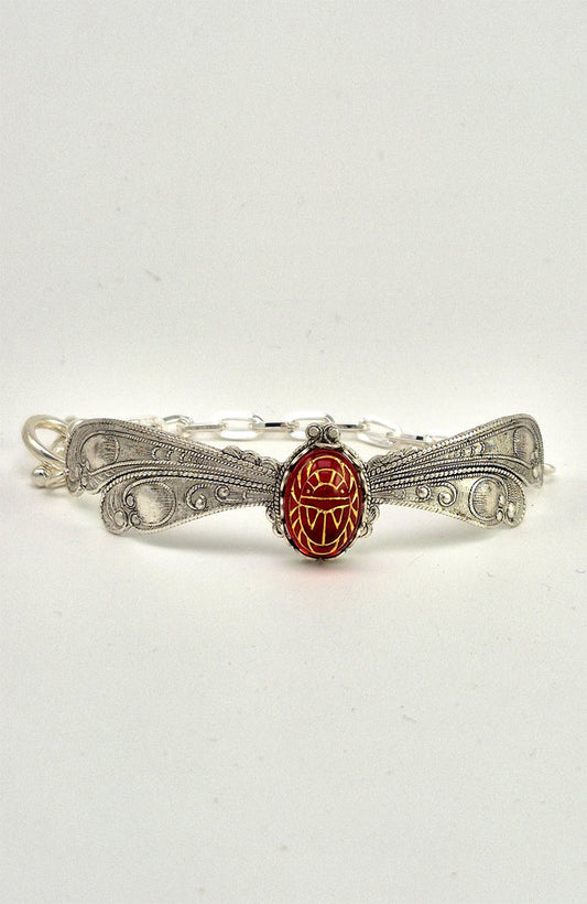 Sterling silver filled Victorian antique or reproduction work from original mold. The bracelet features a silver dragonfly wing design surrounding a central bright ruby coloured antique Art Glass cabochon with an etched scarab design.