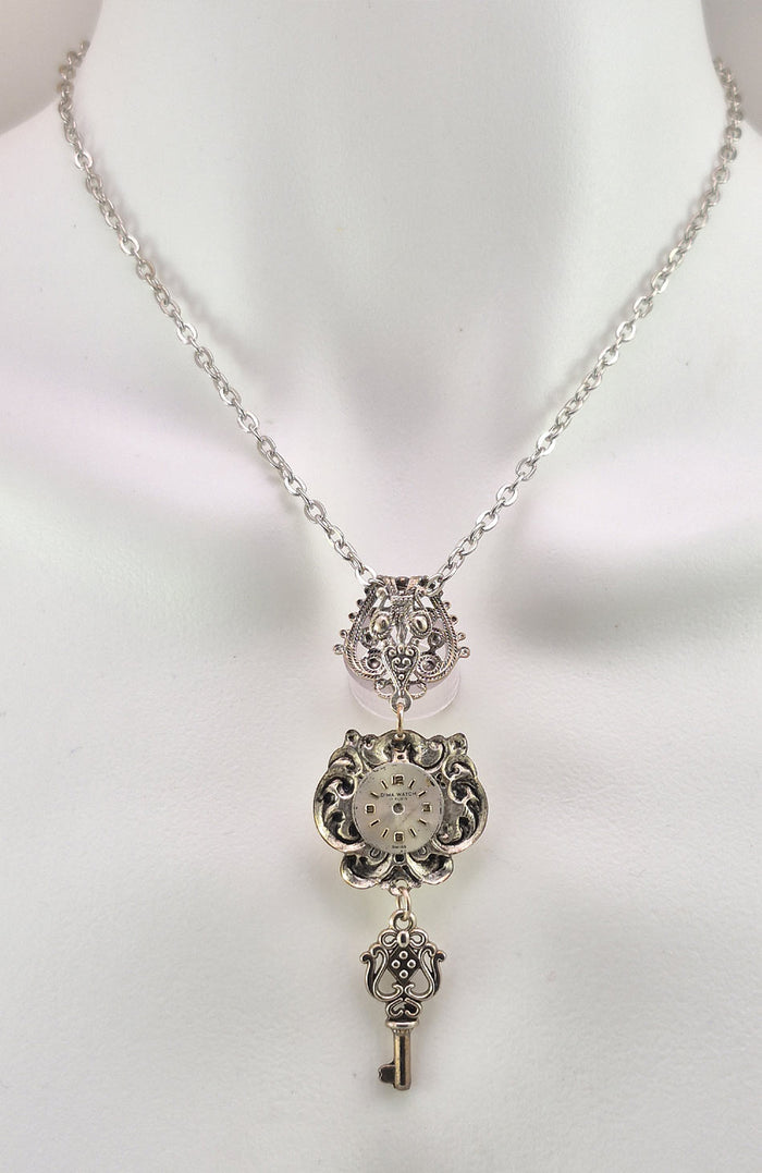 The back side of the pendant is decorated with an antique watch face unique to each piece.