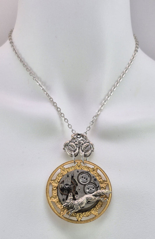 Sterling silver filled Victorian antique or reproduction work from original mold. The pendant features an ornate brass frame  surrounding a large vintage clockworks embellished with a silver fox.