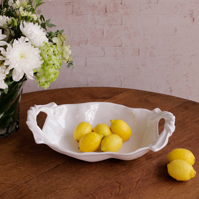 Beatriz Ball Vida Sasha Medium Bowl with Handles White — With lemons beside a floral arrangement