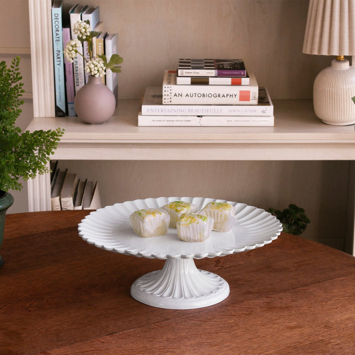 Beatriz Ball Vida Vienna Pedestal Cake Plate White — With small desserts in a room arrangement
